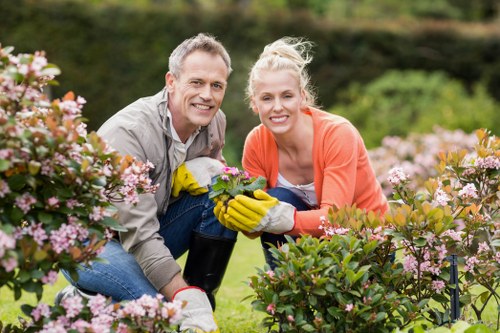 Landscaping crew managing uneven ground and worksite hazards